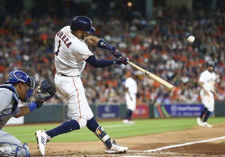 Jun 23, 2018; Houston, TX, USA; Houston Astros shortstop Carlos Correa (1) drives in a run with a sacrifice fly during the fourth inning against the Kansas City Royals at Minute Maid Park. Mandatory Credit: Troy Taormina-USA TODAY Sports