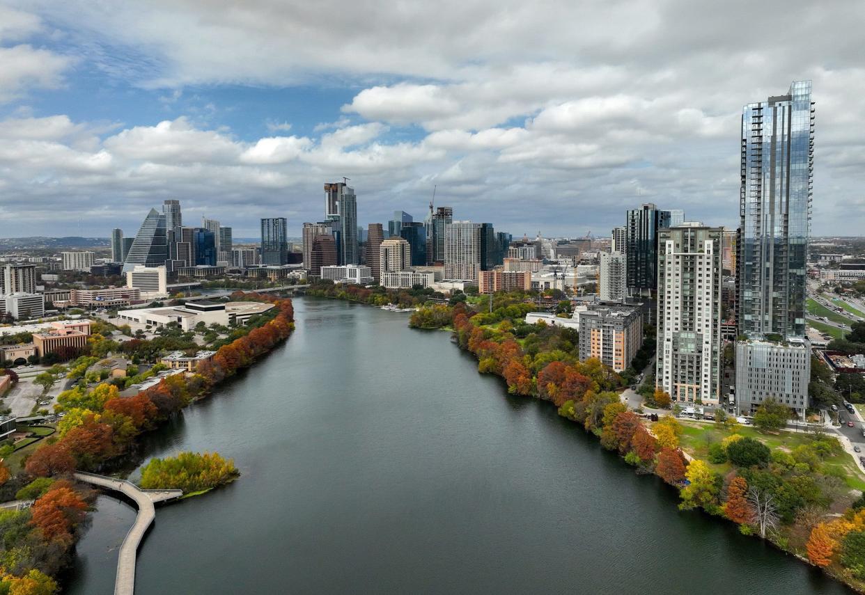 Colorful fall foliage on the banks of Lady Bird Lake in downtown Austin in December 2022. Longtime Austinites remember when it was Town Lake.