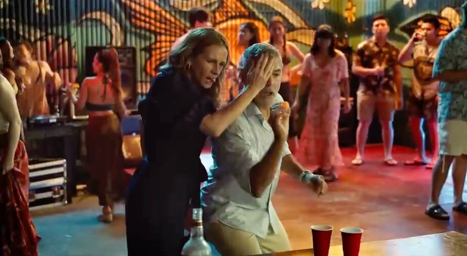 Julia Roberts and George Clooney playing beer pong in Ticket to Paradise