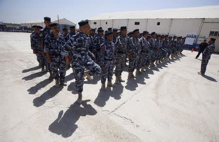 Volunteers, who have joined the Iraqi security forces to fight against the predominantly Sunni militants from the radical Islamic State of Iraq and the Levant (ISIL) who have taken over Mosul and other northern provinces, take part in a training session in their police force uniforms in Kerbala June 17, 2014. REUTERS/Stringer