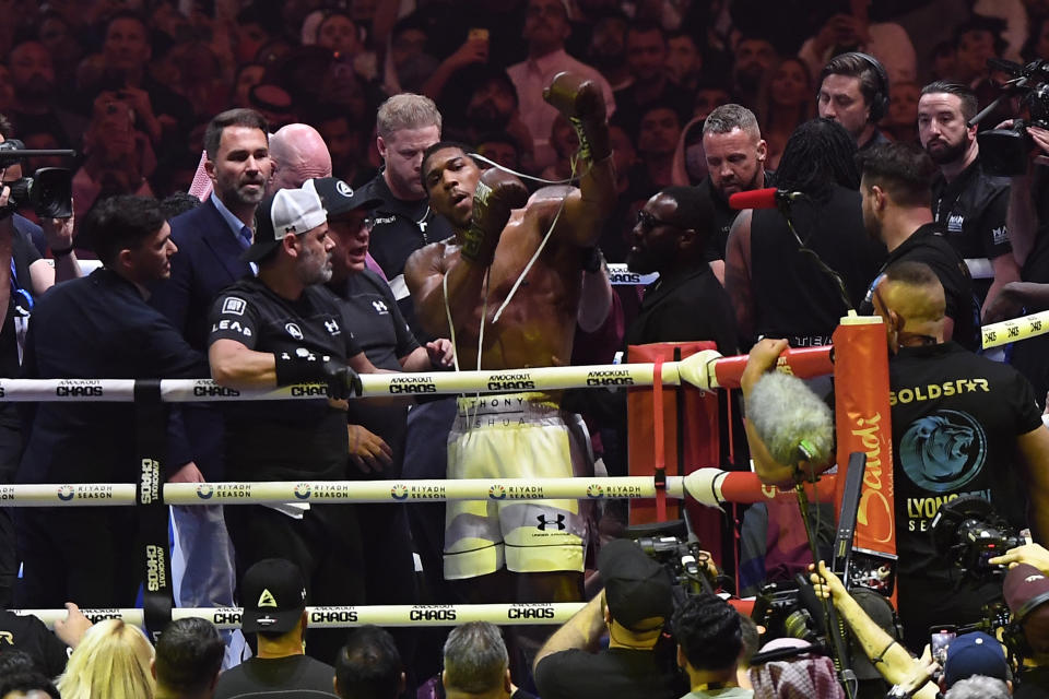 British former world champion Anthony Joshua, center, celebrates after winning the fight against Francis Ngannou during the heavyweight boxing showdown at Kingdom Arena in Riyadh, Saudi Arabia, Saturday, March 9, 2024. (AP Photo)