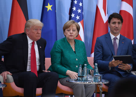 (L-R) US President Donald Trump, German Chancellor Angela Merkel and Canada's Prime Minister Justin Trudeau attend the panel discussion "Launch Event Women's Entrepreneur Finance Initiative" on the second day of the G20 Summit in Hamburg, Germany, July 8, 2017. REUTERS/Patrik STOLLARZ/Pool