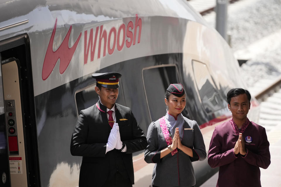 Officials stand near of high-speed railway during the opening ceremony for launching Southeast Asia's first high-speed railway at Padalarang station in Bandung, West Java, Indonesia, Monday, Oct. 2, 2023. Indonesian President Joko Widodo launched Southeast Asia's first high-speed railway that will start its commercial operations on Monday, a key project under China's Belt and Road infrastructure initiative that will cut travel time between two cities from the current three hours to about 40 minutes. (AP Photo/Achmad Ibrahim)