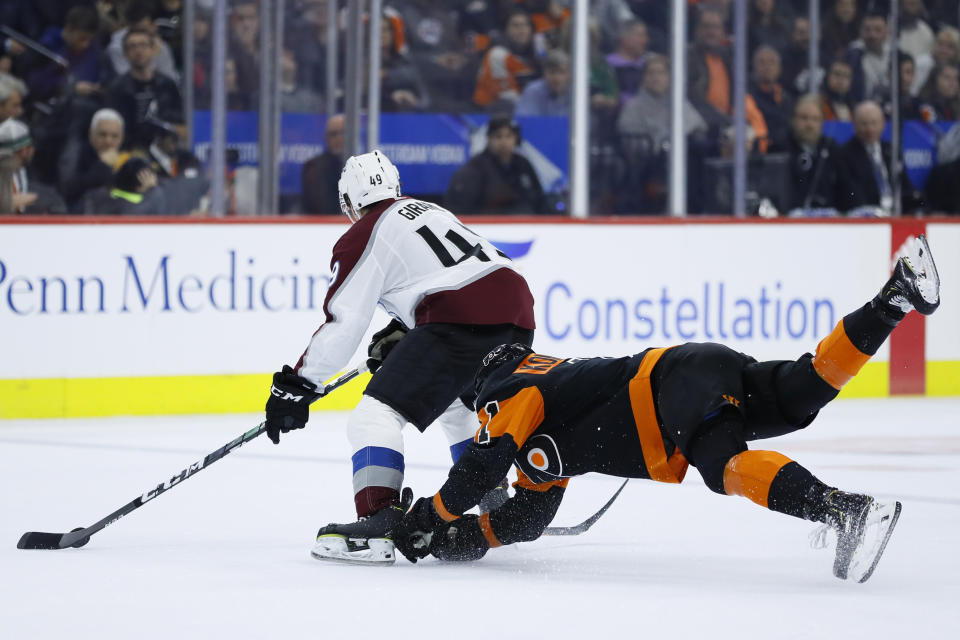 Philadelphia Flyers' Travis Konecny, right, dives after Colorado Avalanche's Samuel Girard during the second period of an NHL hockey game, Saturday, Feb. 1, 2020, in Philadelphia. (AP Photo/Matt Slocum)