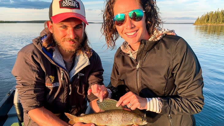 man and woman with fish they caught