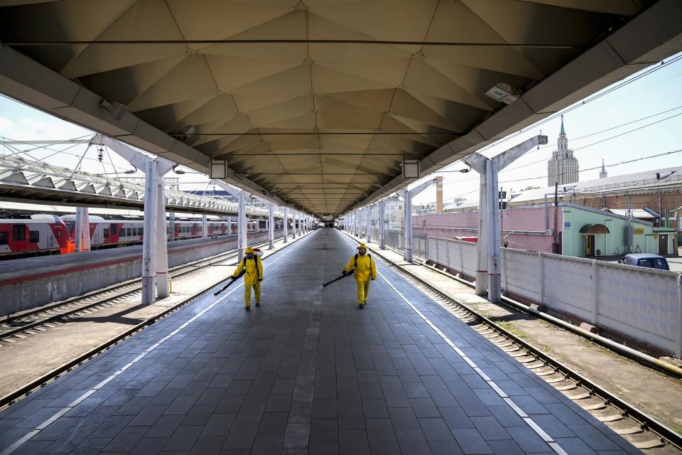 Employees of the Russian Emergency Situations disinfect a platform of Liningradsky railway station in Moscow in Moscow, Russia, Thursday, July 22, 2021. Russia has been facing a sharp increase in coronavirus infections in recent weeks, with the daily tally of confirmed cases going from about 9,000 in early June to over 25,000 in mid-July. On Thursday, the country's state coronavirus task force reported 24,471 new infections and 796 deaths. (AP Photo/Alexander Zemlianichenko)