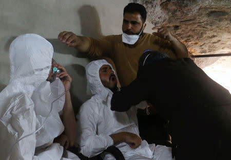 A man breathes through an oxygen mask as another one receives treatments, after what rescue workers described as a suspected gas attack in the town of Khan Sheikhoun in rebel-held Idlib, Syria April 4, 2017. REUTERS/Ammar Abdullah