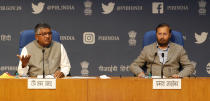 India's Information Technology Minister Ravi Shankar Prasad, left and Information and Broadcasting Minister Prakash Javadekar address a press conference in New Delhi, India, Thursday, Feb. 25, 2021. India on Thursday rolled out new regulations for social media companies and digital streaming websites to make them more accountable for the online content shared on their platforms, giving the government more power to police it. (AP Photo/Manish Swarup)