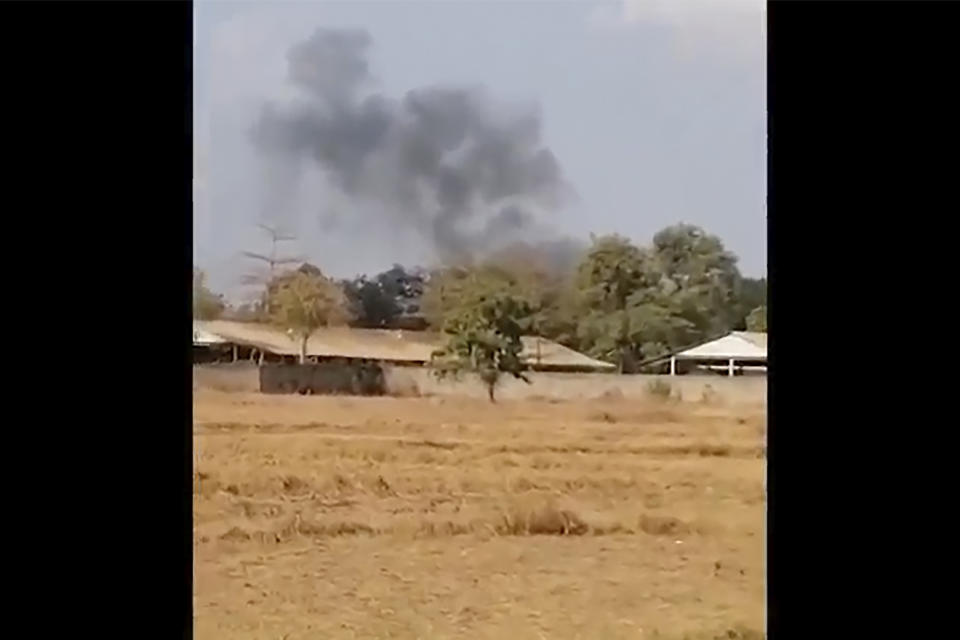 In this image from a video, smoke rises above a distant base, seen from Chbar Mon district in Kompong Speu province, Cambodia Saturday, April 27, 2024. An ammunition explosion at a base in southwestern Cambodia on Saturday afternoon killed multiple soldiers and wounded several others, Prime Minister Hun Manet said. (Chim Sothea via AP)