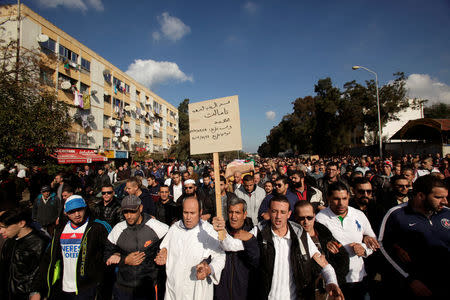 Relatives carry the coffin of British-Algerian journalist Mohamed Tamalt, British-Algerian journalist who had died six months after staging a hunger strike in Algiers over his detention for publishing articles seen as offensive to President Abdelaziz Bouteflika, during his funeral in Algiers, Algeria December 12, 2016. REUTERS/ Ramzi Boudina