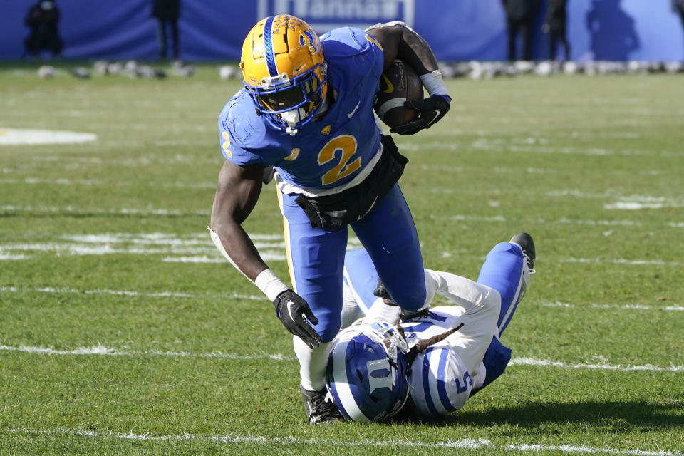 Pittsburgh running back Israel Abanikanda (2) looks for more yardage after a catch in front of Duke defensive back Datrone Young (5) during the first half of an NCAA college football game, Saturday, Nov. 19, 2022, in Pittsburgh. (AP Photo/Keith Srakocic)