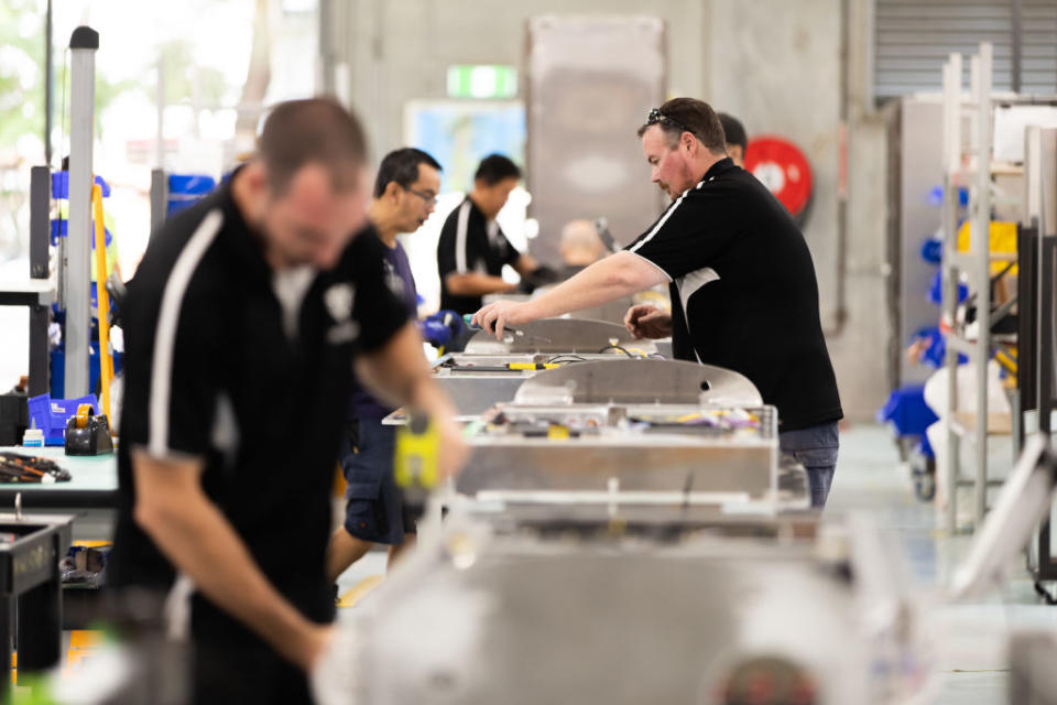 Workers assemble parts for electric vehicle (EV) charging points at the Tritium Pty manufacturing plant in Brisbane, Australia, on Wednesday, March 6, 2019. Photographer: Ian Waldie/Bloomberg