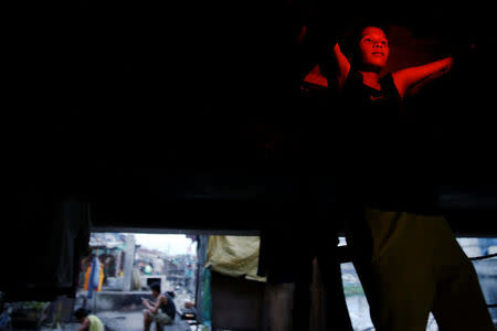 A man enters a space in which he lives under C-3 bridge in North Bay Boulevard South (NBBS), a Navotas City district of slums and waterways with a high number of drug war deaths, in Manila, Philippines November 3, 2016. REUTERS/Damir Sagolj