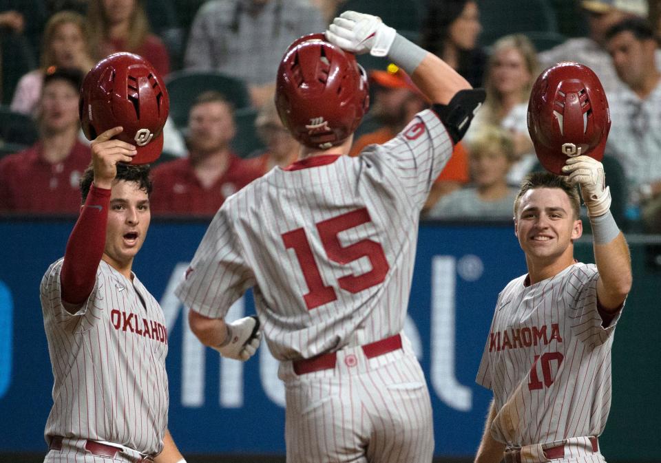OU's Jimmy Crooks, left, and Tanner Treadaway, right, welcome Jackson Nicklaus (15) to home plate after Nicklaus' home run on Thursday.