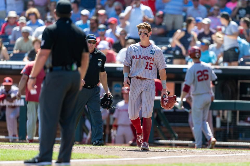 OU's Jackson Nicklaus (15) gets called back to third after an interference call was reversed in the sixth inning in Game 2 of the College World Series finals against Mississippi on Sunday.