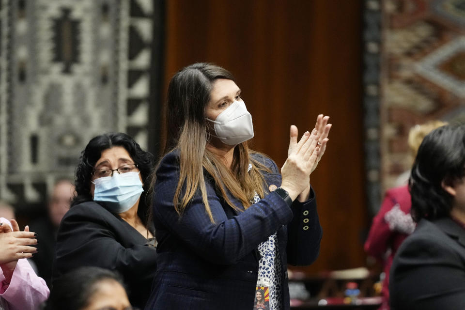 Arizona Sen. Rosanna Gabaldon, D-Sahuarita, left, and Sen. Stephanie Stahl Hamilton, D-Tucson, right, stand and applaud as Arizona Democratic Gov. Katie Hobbs gives the state address at the Arizona Capitol in Phoenix, Monday, Jan. 9, 2023. (AP Photo/Ross D. Franklin)