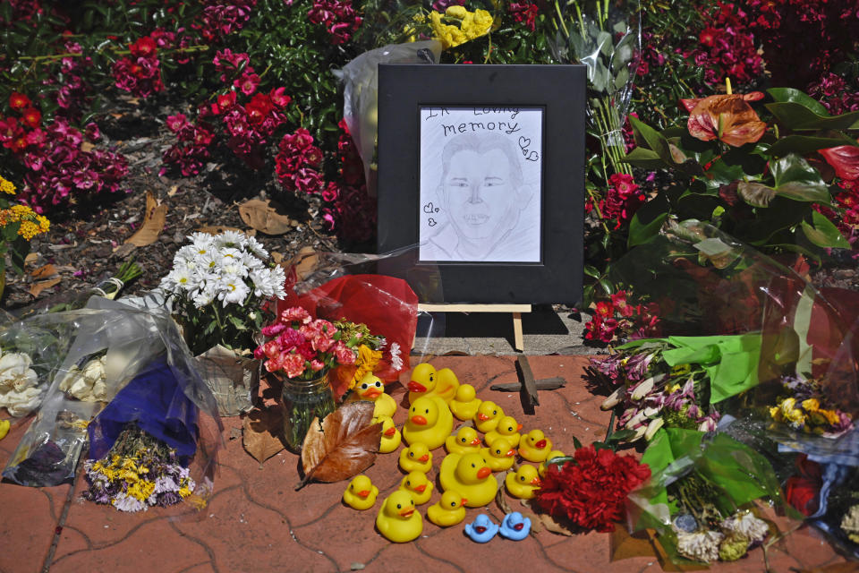 Rubber ducks are placed in a memorial for Casey Rivara that stands at the intersection of Stanford Ranch Road and Park Drive in Rocklin, Calif., Tuesday, May 23, 2023. Rivara was fatally hit by a vehicle on Thursday, May 18, 2023, after helping a mother duck and her offspring cross the street. (Hector Amezcua/The Sacramento Bee via AP)