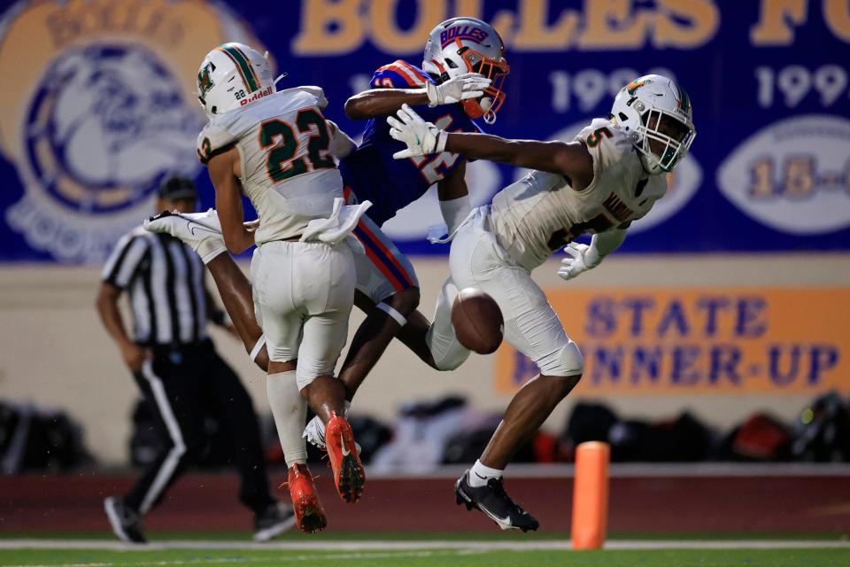 Mandarin's Jon Mitchell (5) breaks up a pass for Bolles receiver Naeem Burroughs, with Mandarin teammate Brayden Knox (22) supporting the play, in a 2022 game.