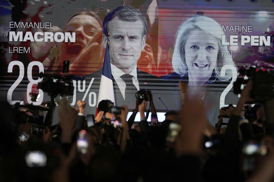 A screen shows French President Emmanuel Macron and far-right candidate Marine Le Pen at her election day headquarters in Paris on Sunday, April 10, 2022. / Credit: Francois Mori/AP