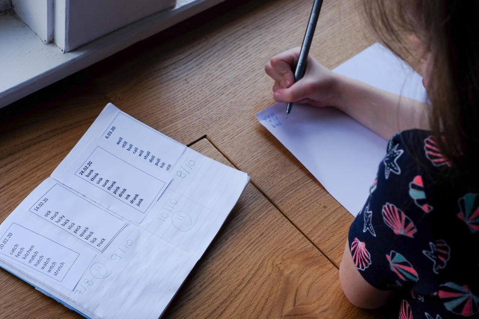 A 6-year-old girl does her Year 1 homework at home as schools are told to close while the UK tackles the Coronavirus outbreak. Photo credit should read: Katie Collins/EMPICS PICTURE POSED BY MODEL