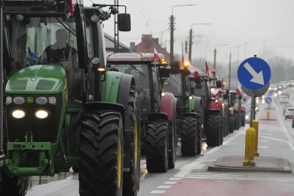 Protesting farmers in Poland are slow-driving their tractors on a road in Deblin, Poland, Wednesday, Jan. 24, 2024 to disturb traffic and draw attention to their disagreement to European Union regulations. Such protests were held across Poland. (AP Photo/Czarek Sokolowski)