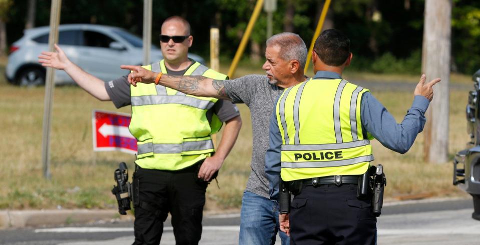 Jackson Township Mayor Michael Renna speaks to police officers redirecting traffic at East Commodore Boulevard and Cedar Swamp Road as a nearby brush fire is battled Tuesday evening, June 6, 2023.