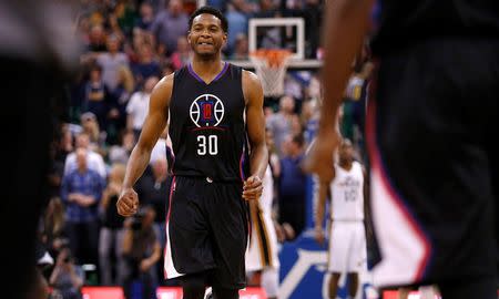 Apr 8, 2016; Salt Lake City, UT, USA; Los Angeles Clippers guard C.J. Wilcox (30)reacts after teammate guard Jamal Crawford (11) hit the game winning shot in overtime against the Utah Jazz at Vivint Smart Home Arena. The Los Angeles Clippers defeated the Utah Jazz 102-99 in overtime. Mandatory Credit: Jeff Swinger-USA TODAY Sports