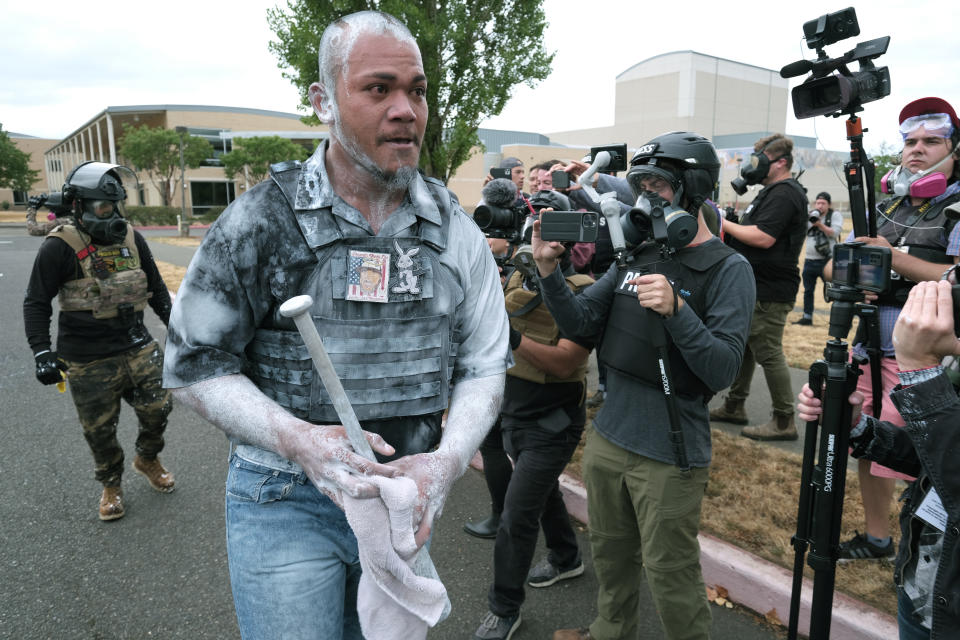 Proud Boy Tusitala "Tiny" Toese walks away after speaking to the press following clashes with anti-fascist protesters on Sunday, Aug. 22, 2021, in Portland, Ore. (AP Photo/Alex Milan Tracy)