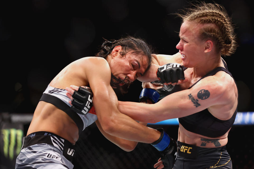 Defending UFC women's flyweight champion Valentina Shevchenko (right) exchanges strikes with challenger Taila Santos of Brazil during the UFC 275 fight event at Singapore Indoor Stadium. 