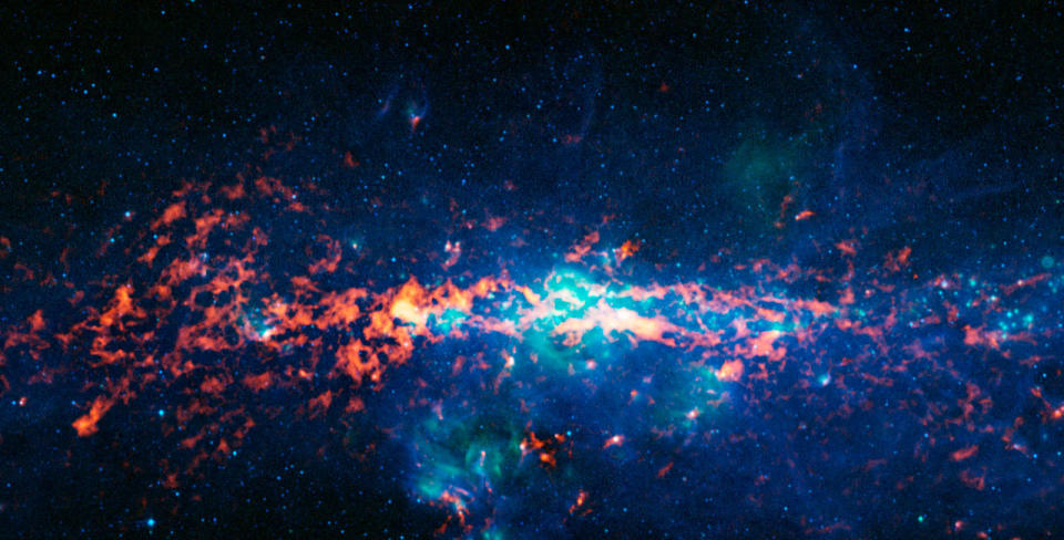 Color composite image of the Galactic Center and Sagittarius B2, as seen by the ATLASGAL survey.  At the center of the Milky Way is a supermassive black hole that has more than four million times the mass of our Sun.  It is located approximately 25,000 light years from Earth.  Sagittarius B2 (Sgr B2) is one of the largest clouds of molecular gas in the Milky Way.