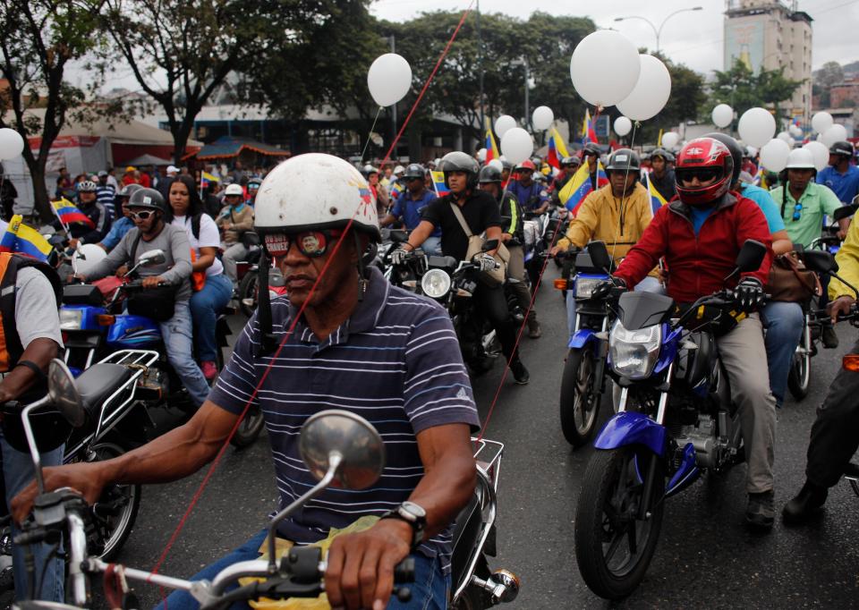 Motorcyclists attend a rally in support of Venezuela's President Nicolas Maduro in Caracas, Venezuela, Monday, Feb. 24, 2014. Opposition protesters erected barricades across major thoroughfares on Monday, bringing traffic to a halt in parts of the Venezuelan capital in a continuation of the unrest that has roiled the country for nearly two weeks. The demonstrators blame Maduro's administration for the country's high crime rate and economic troubles. (AP Photo/Rodrigo Abd)