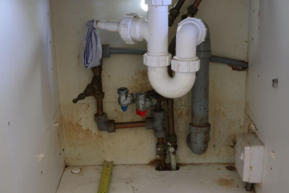 messy cupboard under sink