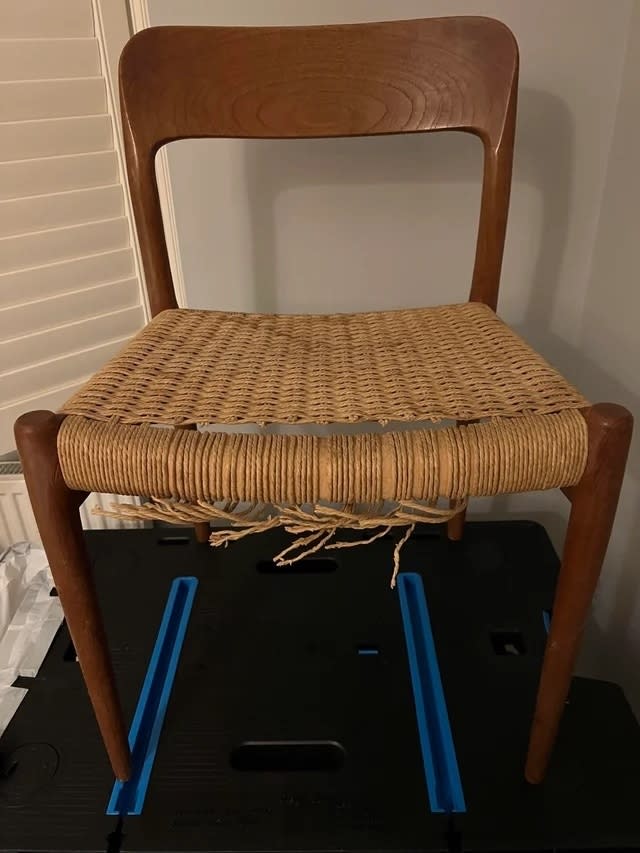 A before image of a teak chair with broken caning