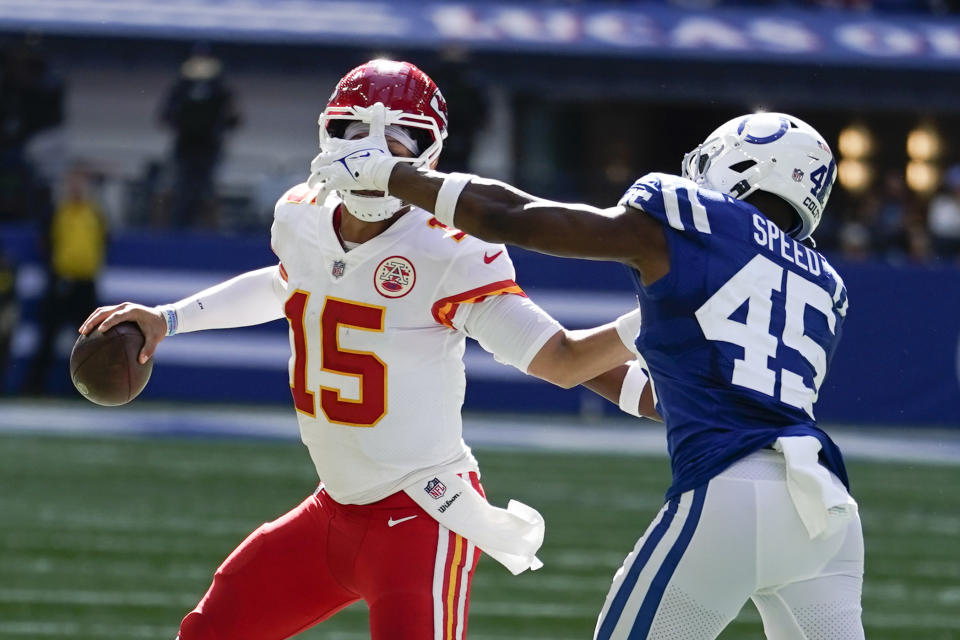 Kansas City Chiefs quarterback Patrick Mahomes (15) is chased by Indianapolis Colts' E.J. Speed (45) during the second half of an NFL football game, Sunday, Sept. 25, 2022, in Indianapolis. (AP Photo/Michael Conroy)