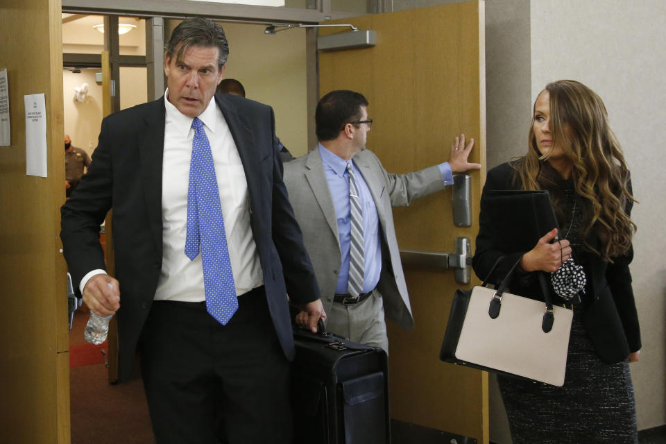 R. Kevin Butler, left, David A. Cincotta, center, and Sadie J. Flynn, right, defense attorneys for Max Townsend, leave the courtroom during a break in the preliminary hearing for Townsend in Norman, Okla., Friday, July 24, 2020. Townsend is accused of killing three Moore High School cross-county runners and injuring several others in an alleged hit and run crash. (AP Photo/Sue Ogrocki)