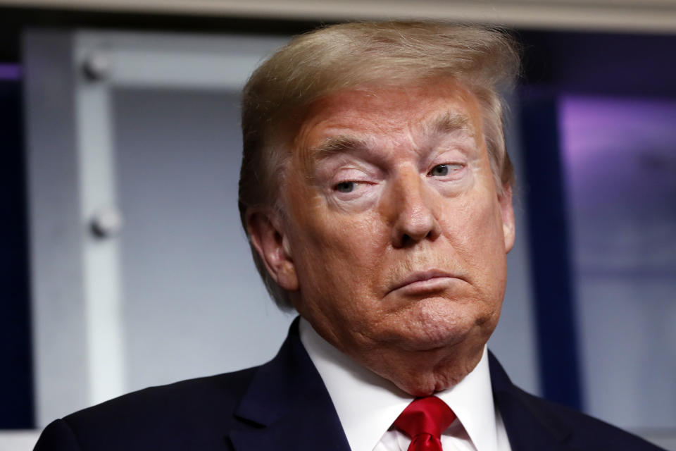 President Donald Trump listens as Agriculture Secretary Sonny Perdue speaks about the coronavirus in the James Brady Press Briefing Room of the White House, Friday, April 17, 2020, in Washington. (AP Photo/Alex Brandon)