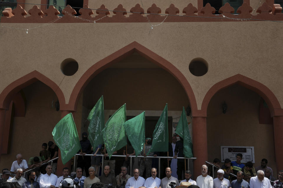 FILE - Hamas supporters and masked militants from the Izzedine al-Qassam Brigades, the military wing of Hamas, wave the green flags of the Islamist group during a protest in support of Palestinian prisoners in Israeli jails, after Friday prayer in Nusseirat refugee camp, central Gaza Strip, Friday, Aug. 18, 2023. It has become an Israeli mantra throughout the latest war in Gaza: Hamas is ISIS. Since the bloody Hamas attack on Oct. 7 that triggered the war, Israeli leaders and commanders have likened the Palestinian militant group to the Islamic State group. They point to Hamas’ brutal slaughter of hundreds of civilians and compare their Gaza war to the U.S.-led campaign to defeat IS in Iraq and Syria. (AP Photo/Adel Hana, File)