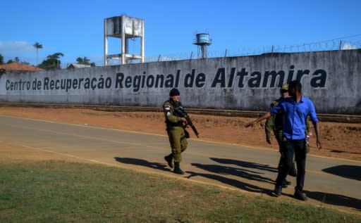 A police officer patrols the surroundings of the Altamira Regional Recovery Center after at least 57 inmates were killed during a prison riot, in the northern Brazilian city of Altamira, Para State