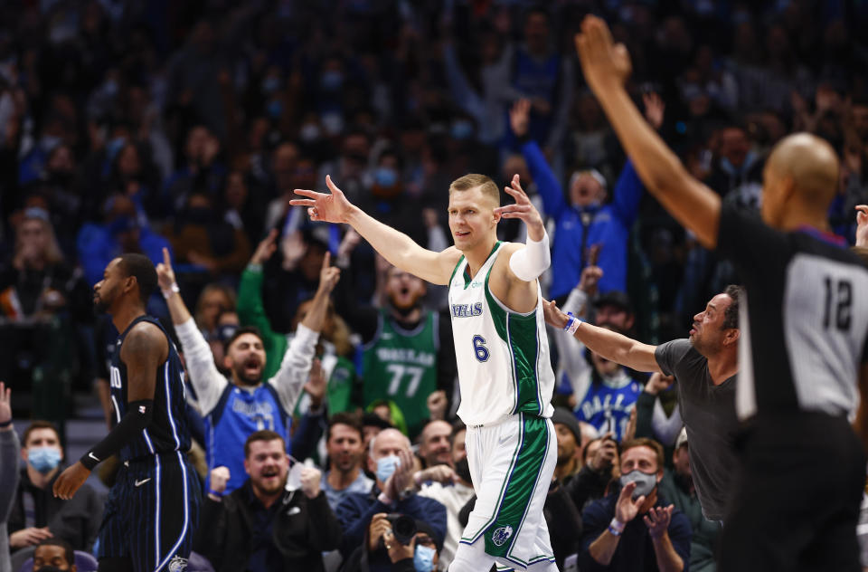 Dallas Mavericks forward Kristaps Porzingis (6) celebrates a three-point basket at the buzzer at the end of the first quarter of an NBA basketball game against the Orlando Magic, Saturday, Jan. 15, 2022, in Dallas. (AP Photo/Brandon Wade)