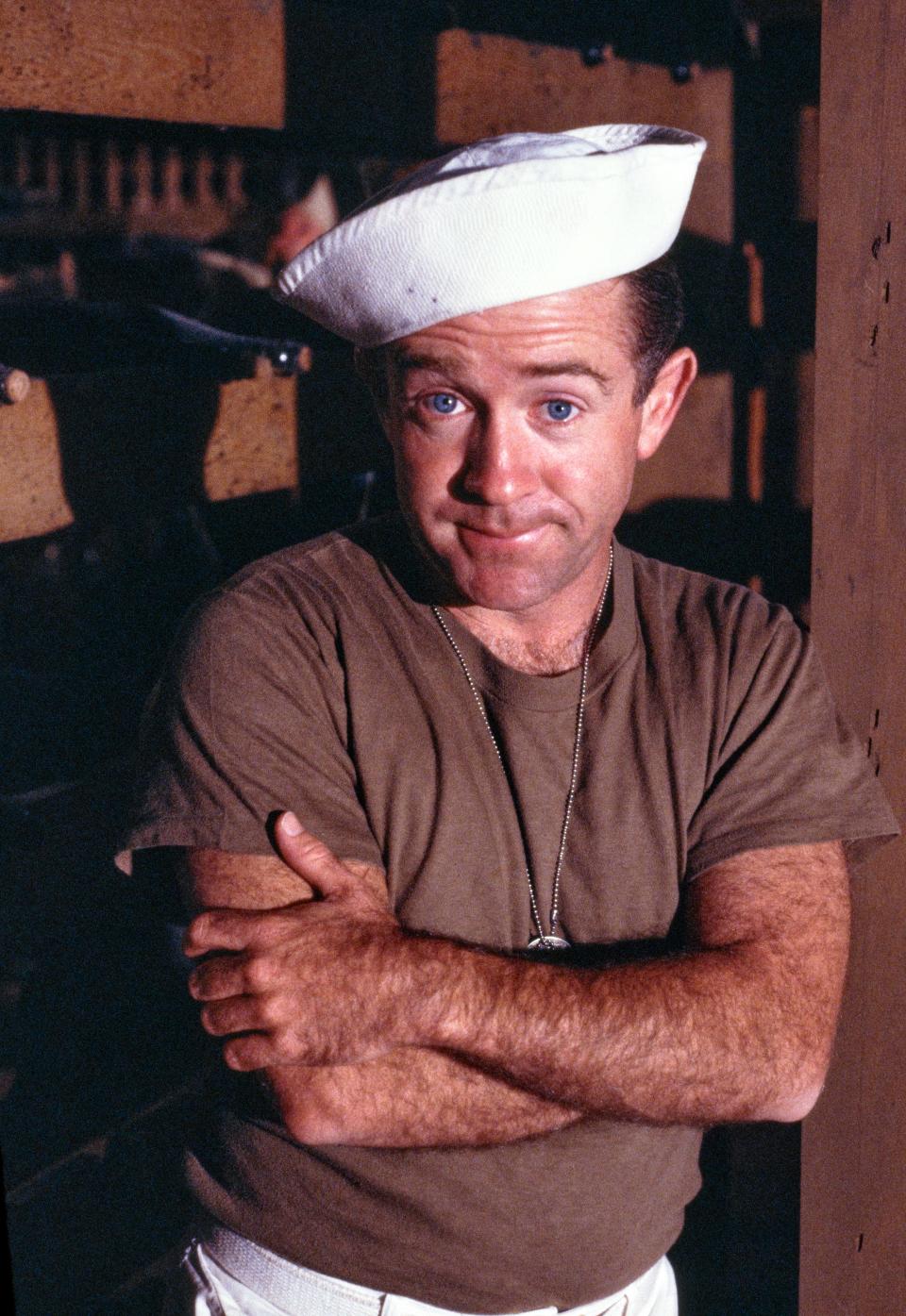 Leslie Jordan in a sailor's cap crossing his arms