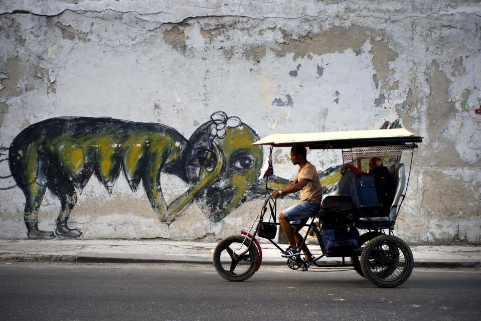 In this Feb. 12, 2017 photo, the work of urban artist Yulier P. adorns a wall on a street in Havana, Cuba. Cuba has long had a thriving art scene and there has in recent years been a boom for works by some of the island's most famous painters. But the 27-year-old artist, whose full name is Yulier Rodríguez Pérez did not emerge from the artistic establishment and the kind of urban art he practices is unusual here. (AP Photo/Ramon Espinosa)