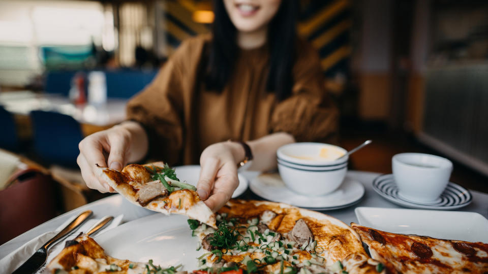 Woman eating pizza