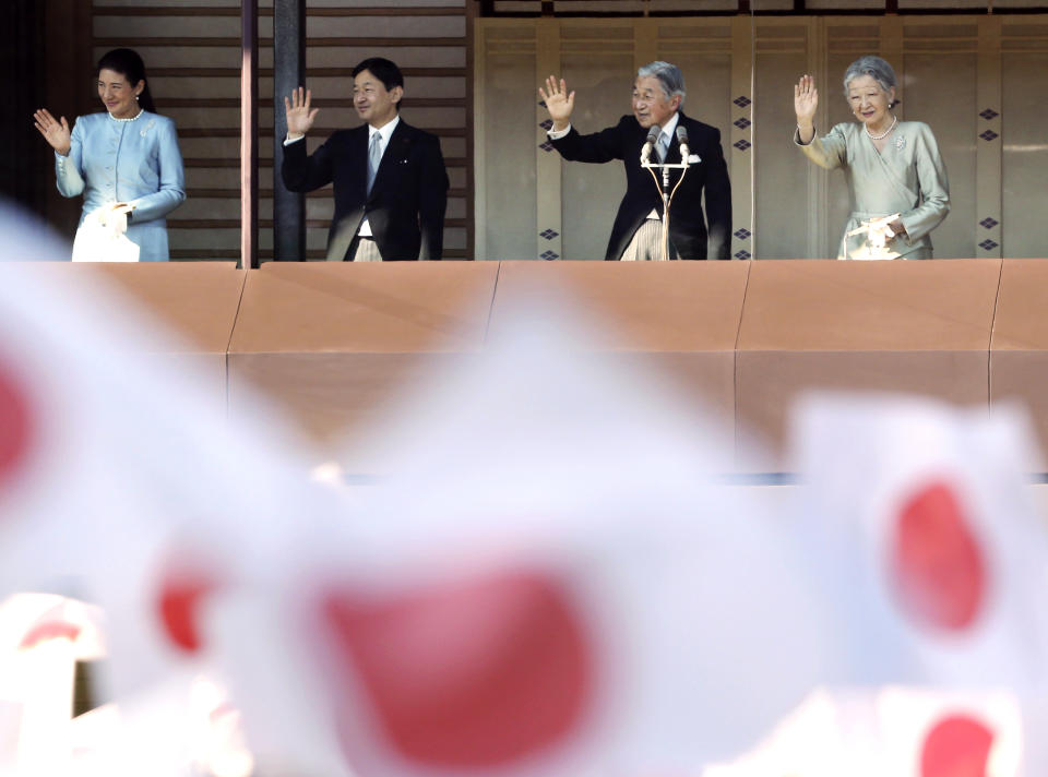 FILE - In this Jan. 2, 2014, file photo, Japan's Crown Prince Naruhito, second from left, and Crown Princess Masako, left, Japan's Emperor Akihito, and Empress Michiko wave to well-wishers from a balcony during a New Year's public appearance at Imperial Palace in Tokyo. Naruhito, Japan’s future new emperor is a musician and historian who is expected to bring a global perspective to an ancient institution when he ascends the Chrysanthemum Throne on Wednesday, May 1, 2019. (AP Photo/Koji Sasahara, File)