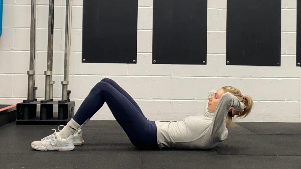 Pilates teacher Lotty performing the ab curl