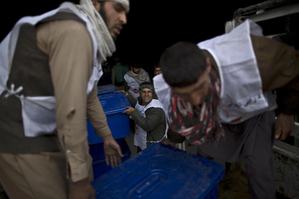 Afghan election workers load ballot boxes and election materials into a truck to be delivered to polling stations, at a warehouse in Kabul, Afghanistan, Thursday, April 3, 2014. Elections will take place on April 5. (AP Photo/Muhammed Muheisen)