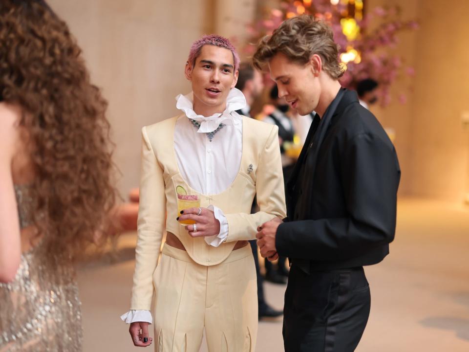 Evan Mock and Austin Butler talk at the Met Gala on May 2, 2022.