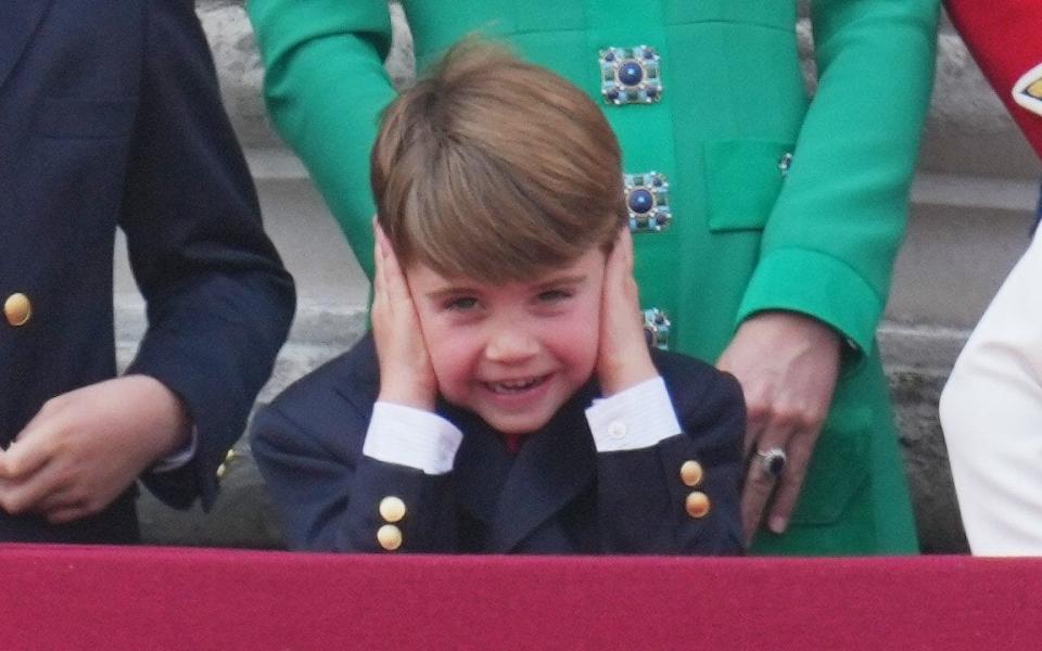 Prince Louis covers his ears as planes fly above - James Whatling