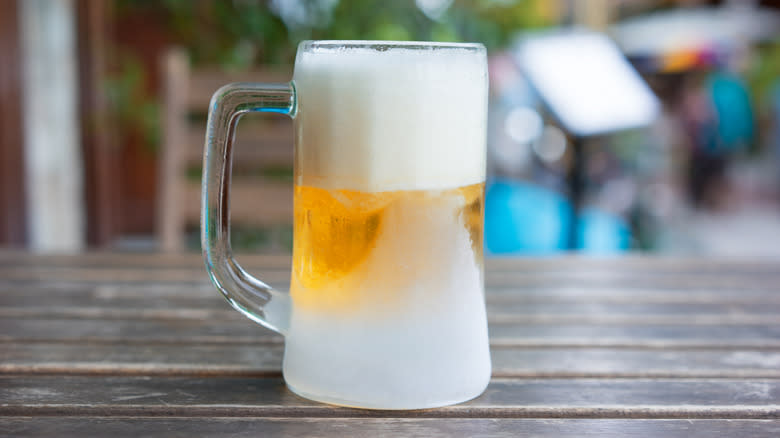 Frost-covered glass beer mug with thick head