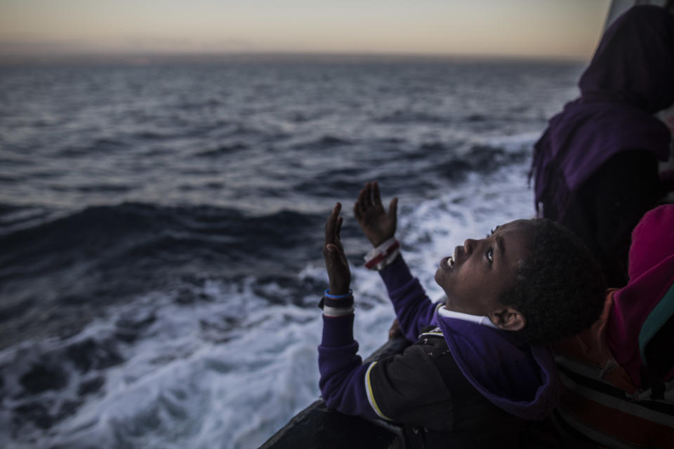 FILE - In this Thursday Jan. 18, 2018 file photo a child from Eritrea sings to celebrate his arrival to Europe aboard the Spanish NGO Proactiva Open Arms rescue vessel near Pozzallo, Sicily, Italy. (AP Photo/Santi Palacios, File)