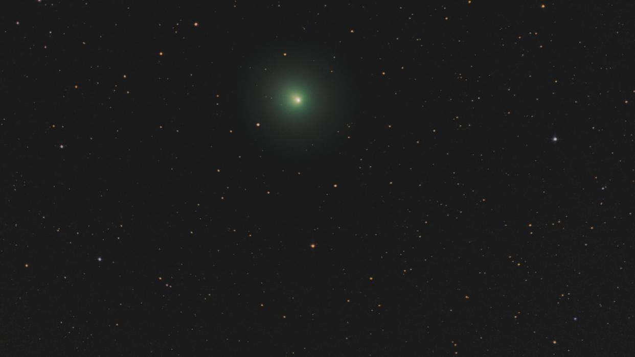  Aa green comet in the night sky. 